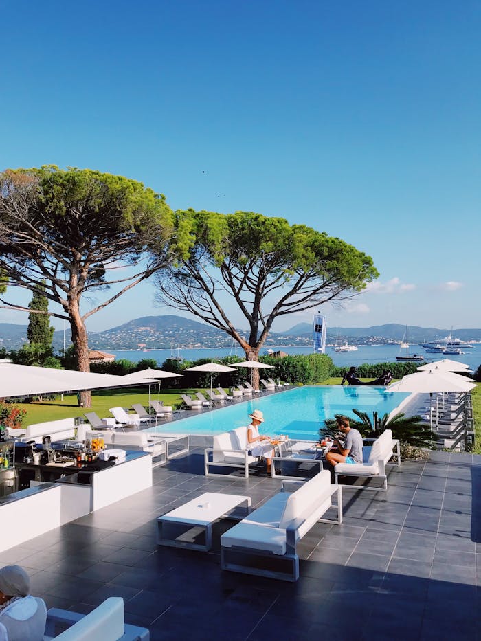 Relax by the infinity pool at a Saint-Tropez resort with stunning Mediterranean views.