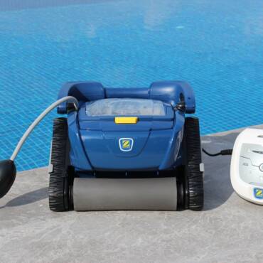 Robotic pool cleaner on pool edge in Bodrum, Turkey. Efficient and modern.